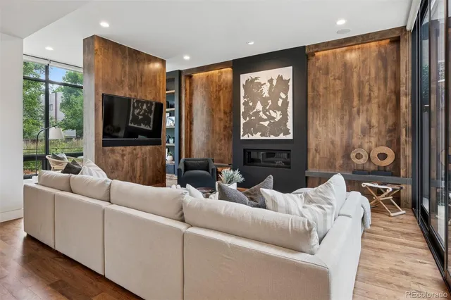 a living room with furniture tv and a large window