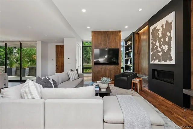 a living room with furniture tv and large window