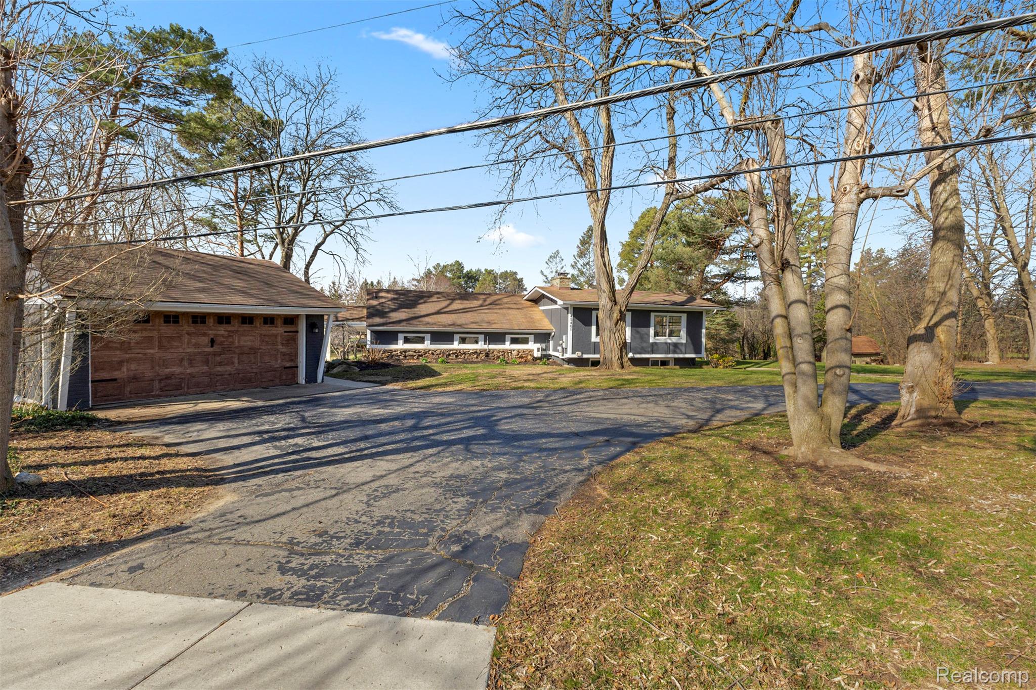45401 West 9 Mile Road Novi, MI 48374 - Photo 32 of 67 View of front facade featuring a garage, a front yard, and asphalt driveway