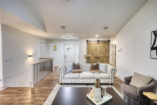 a kitchen with stainless steel appliances a stove a chimney a sink and cabinets