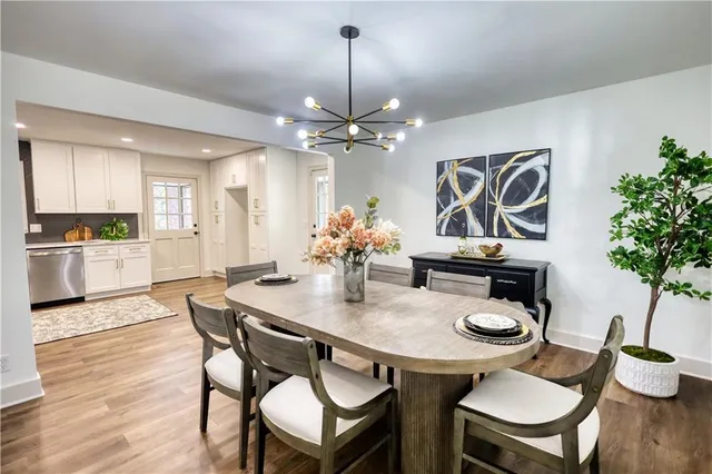 a bedroom with a bed and a lamp on dresser