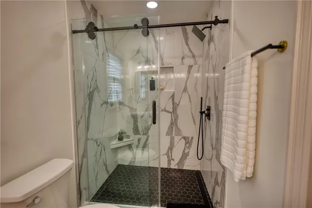 a bedroom with a bed and flat screen tv