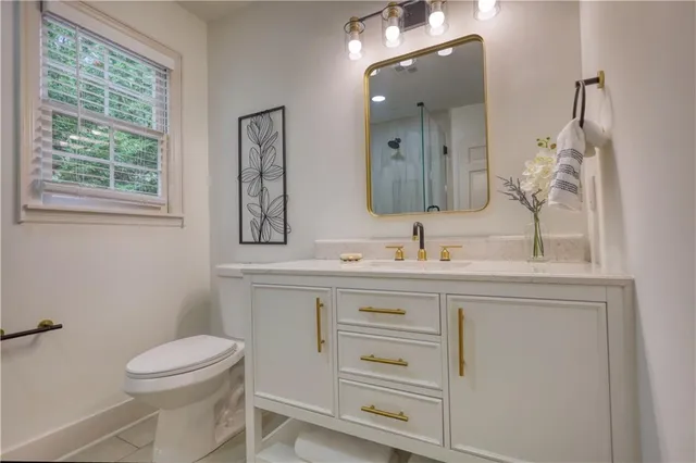 an aerial view of residential house with outdoor space and trees all around