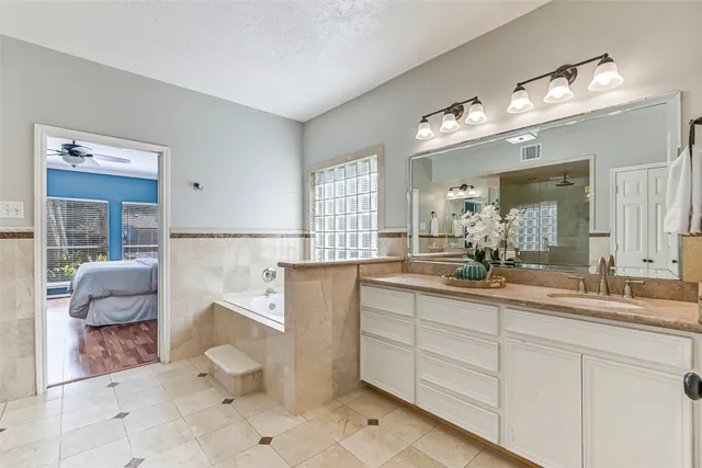 a spacious bathroom with a double vanity sink and a mirror