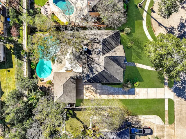 an aerial view of a house with outdoor space