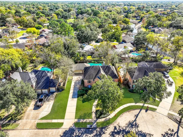 an aerial view of a house with a yard and lake view