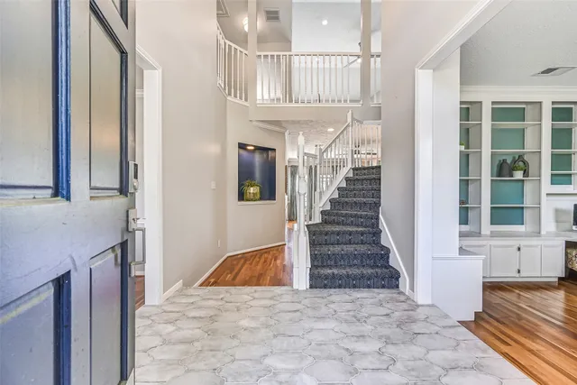 a view of entryway and hall with wooden floor