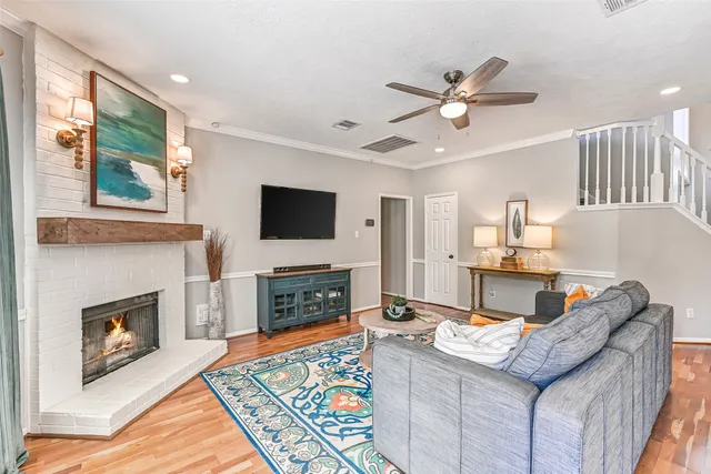 a living room with furniture a fireplace and a flat screen tv