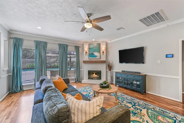 a living room with fireplace furniture and a flat screen tv