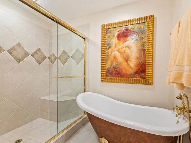 a bathroom with a bathtub and shower