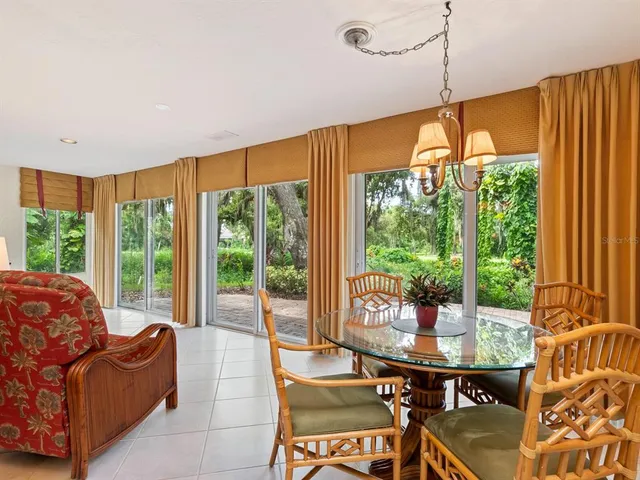 a living room with furniture fireplace and large windows