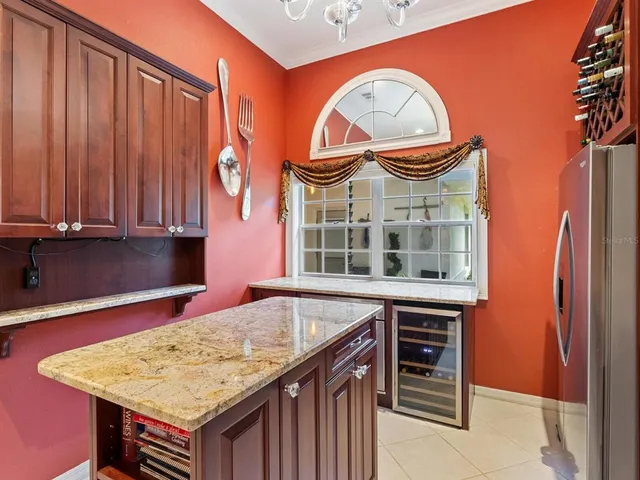 an aerial view of a kitchen island a chandelier wooden floor and kitchen view