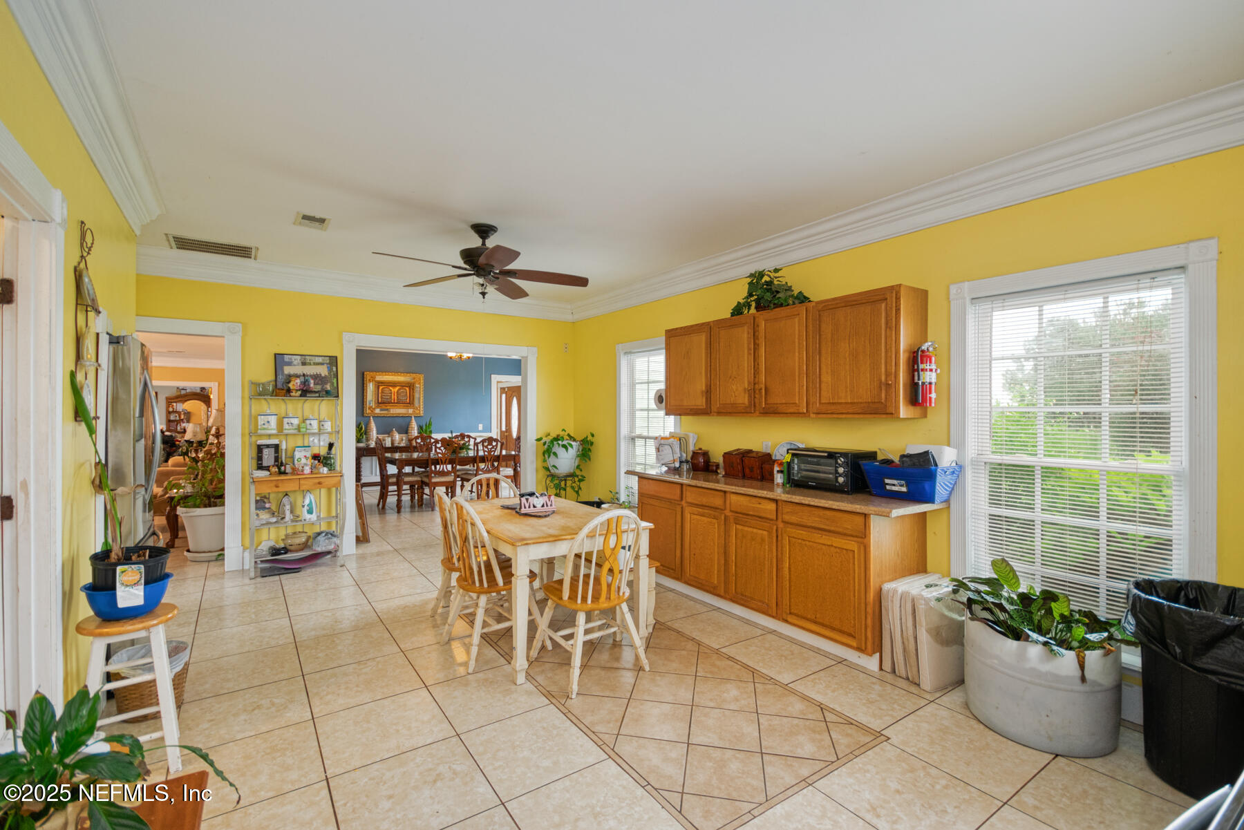 3704 Northeast Rocky Ford Road Madison, FL 32340 - Photo 15 of 34 a kitchen with stainless steel appliances kitchen island granite countertop a table and chairs in it