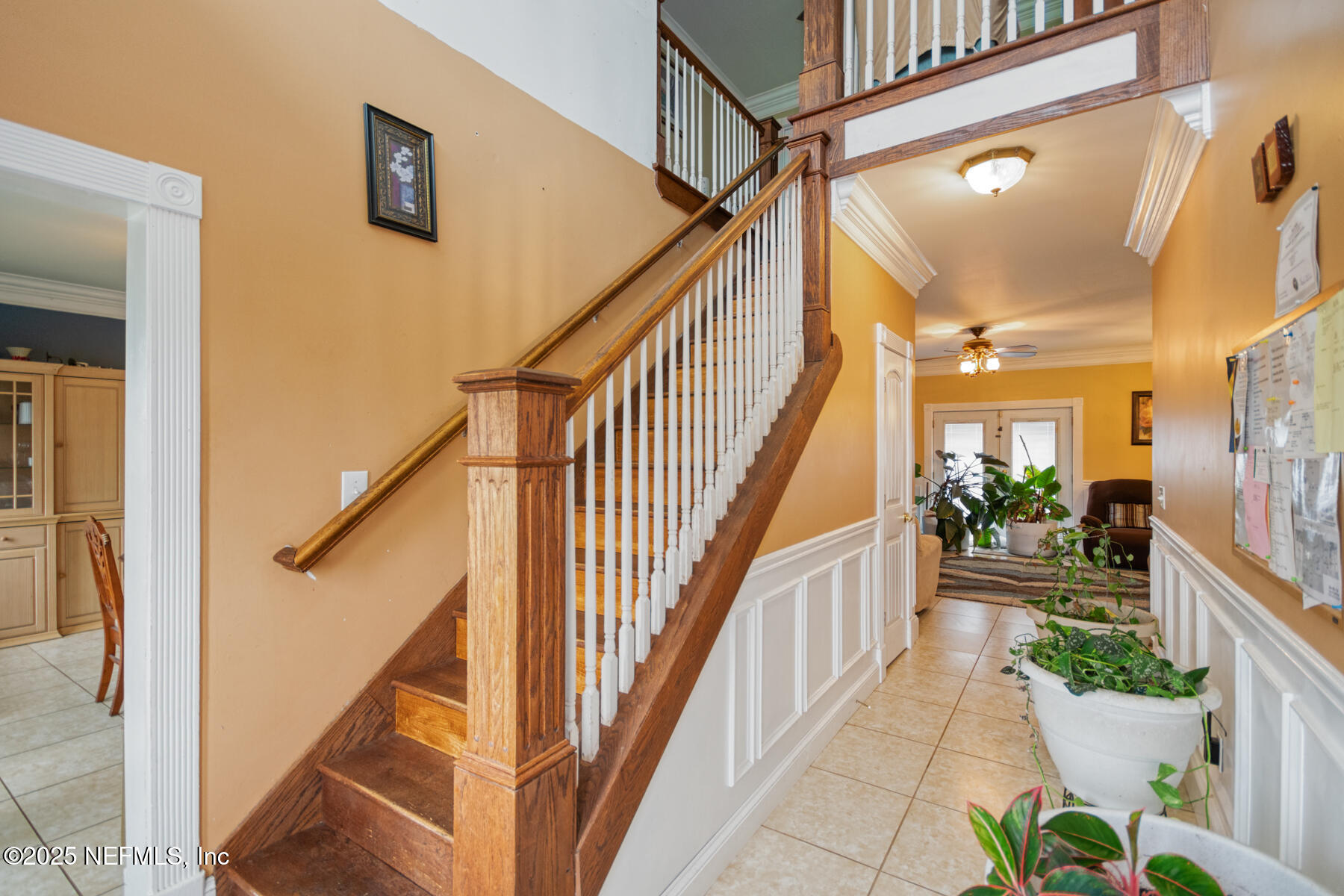 3704 Northeast Rocky Ford Road Madison, FL 32340 - Photo 4 of 34 a view of staircase with lots of frames on wall and a chandelier
