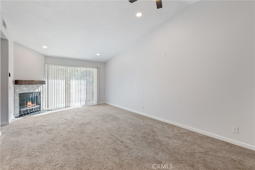 10 Timbre Rancho Santa Margarita, CA 92688 - Photo 4 of 24 a view of an empty room with a fireplace and a window