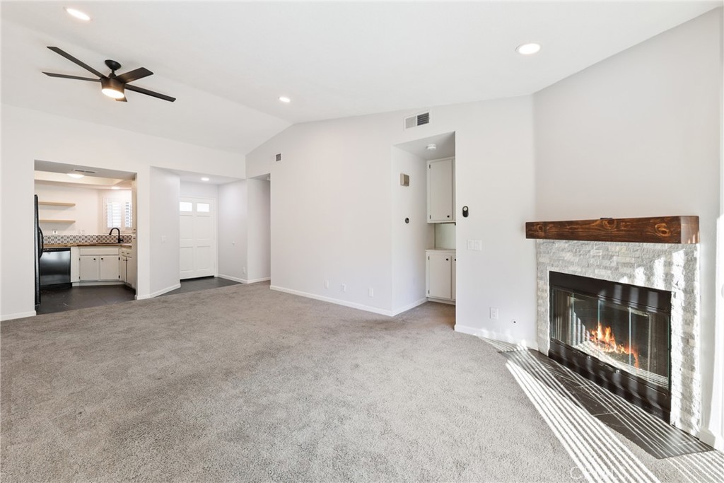 10 Timbre Rancho Santa Margarita, CA 92688 - Photo 7 of 24 a view of a livingroom with a fireplace a ceiling fan and staircase
