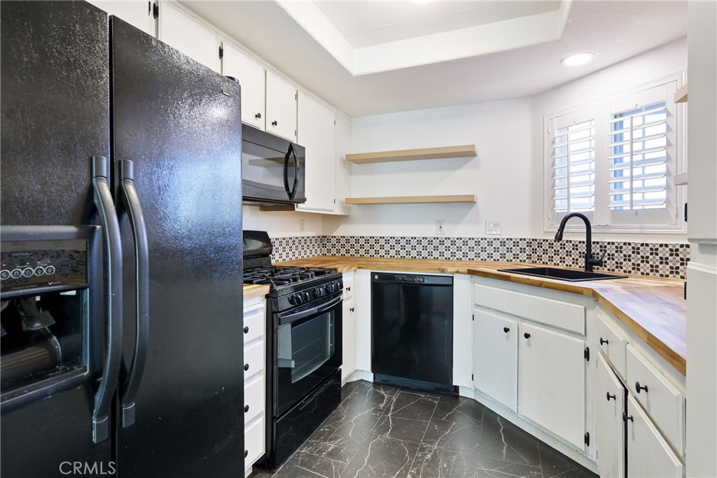 10 Timbre Rancho Santa Margarita, CA 92688 - Photo 8 of 24 a kitchen with stainless steel appliances granite countertop a refrigerator and a sink