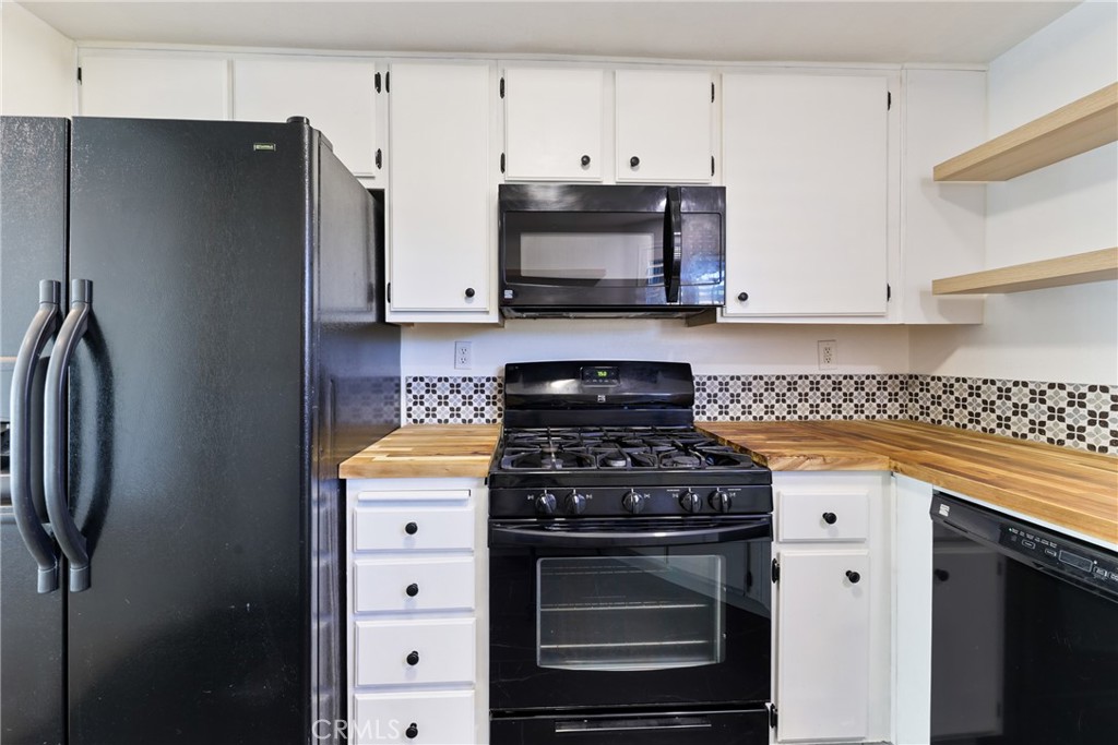 10 Timbre Rancho Santa Margarita, CA 92688 - Photo 8 of 24 a kitchen with stainless steel appliances granite countertop a stove a refrigerator and a white cabinets