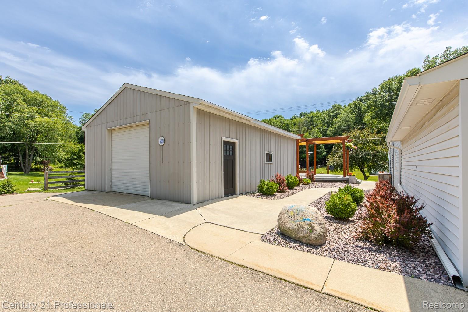 1790 Kent Road Ortonville, MI 48462 - Photo 53 of 64 Detached garage with a roll-up door and separate entry door