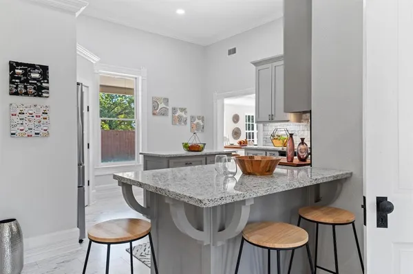 a view of a kitchen area with furniture and a potted plant