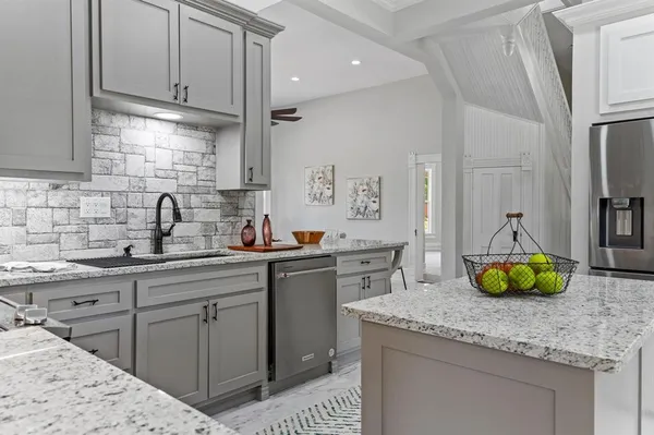 a kitchen with a sink a stove and cabinets