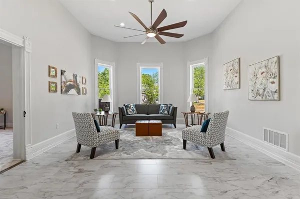 a living room with furniture and a large window