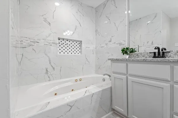 a bathroom with a bathtub and a sink