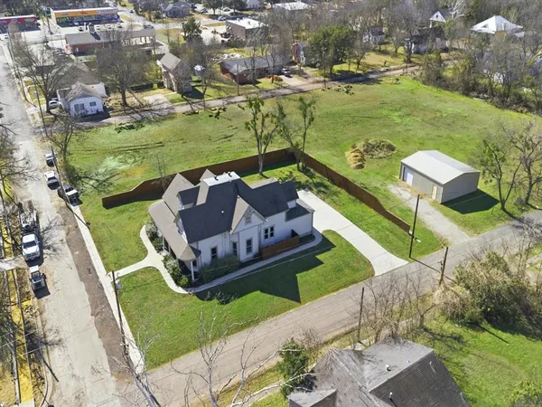 an aerial view of a house with a garden and lake view