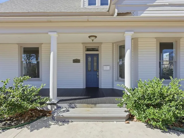 a kitchen with stainless steel appliances granite countertop a stove top oven a sink dishwasher and white cabinets with wooden floor