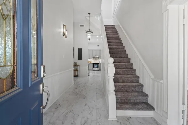 a view of entryway and hall with wooden floor