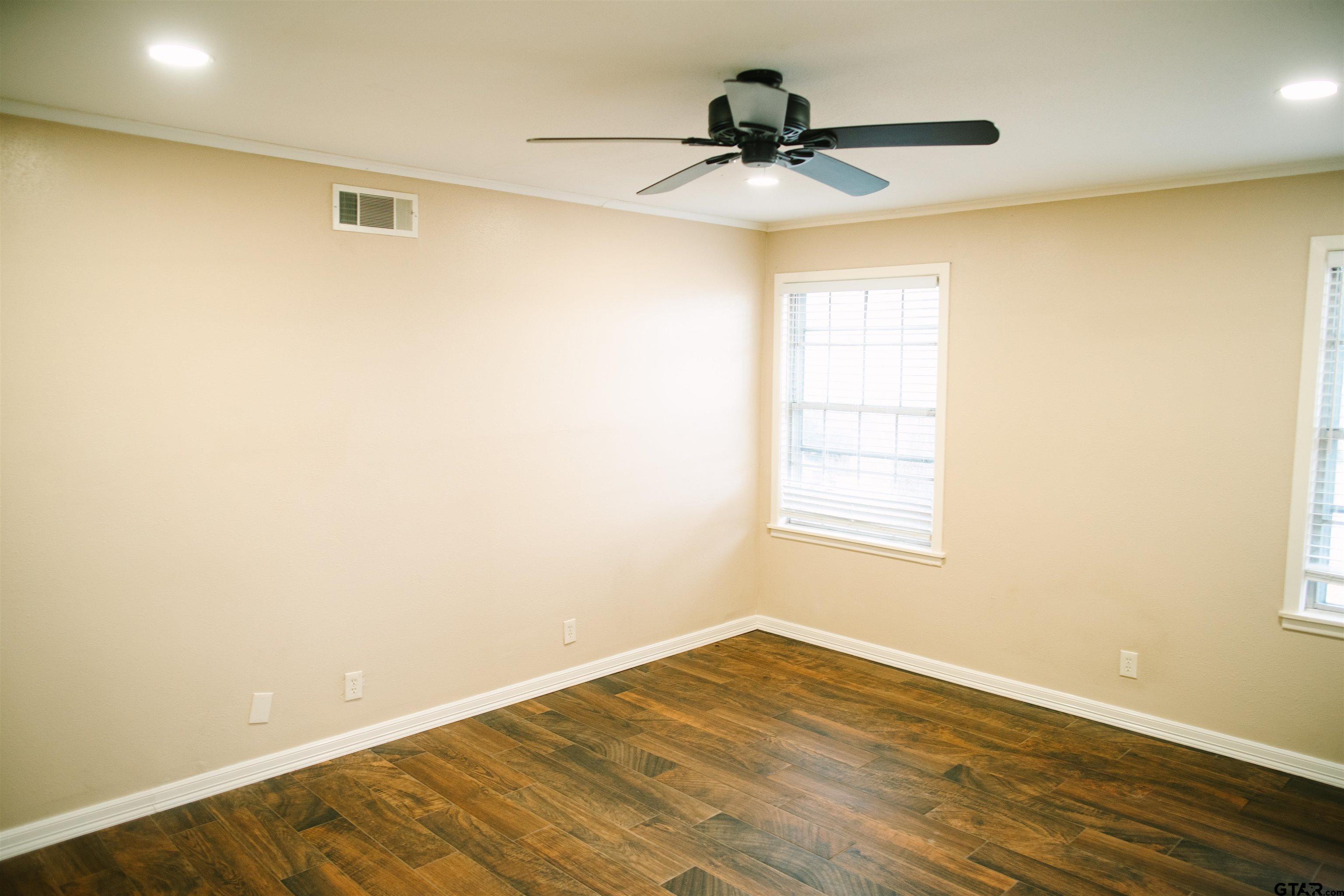 1823 Overbrook Drive Tyler, TX 75703 - Photo 12 of 48 a view of empty room with wooden floor and fan