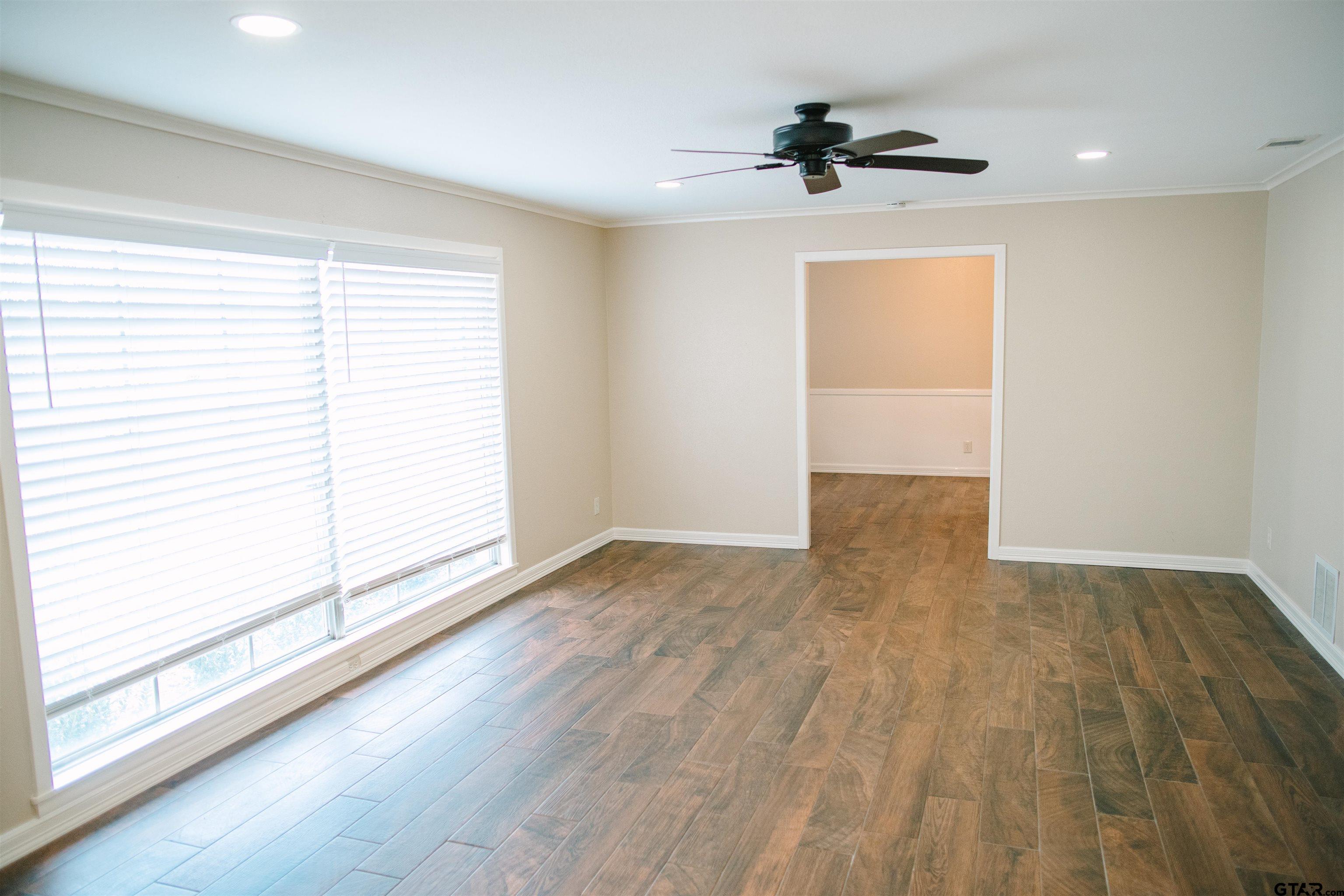 1823 Overbrook Drive Tyler, TX 75703 - Photo 13 of 48 an empty room with wooden floor and windows