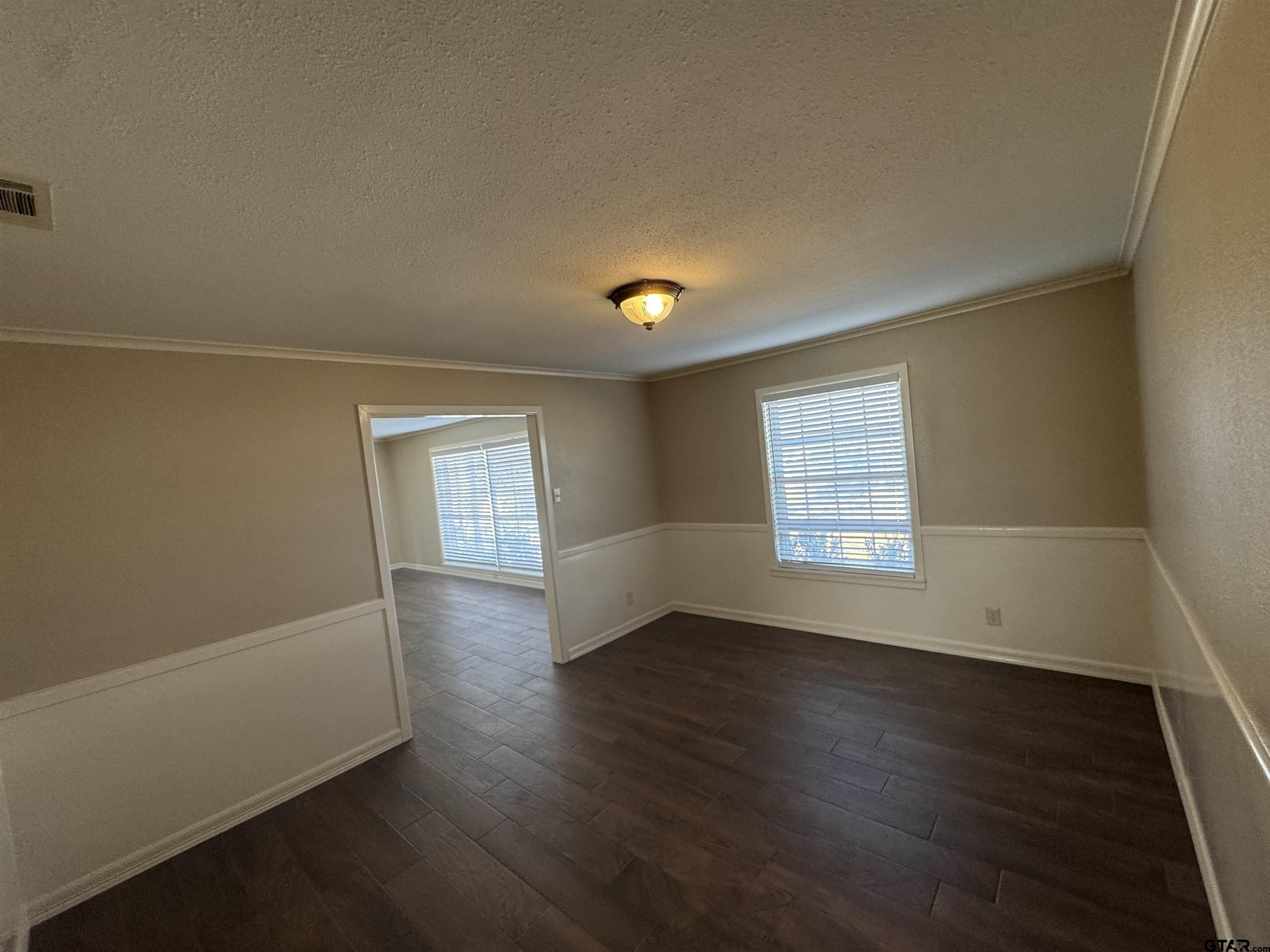 1823 Overbrook Drive Tyler, TX 75703 - Photo 16 of 48 an empty room with wooden floor and windows