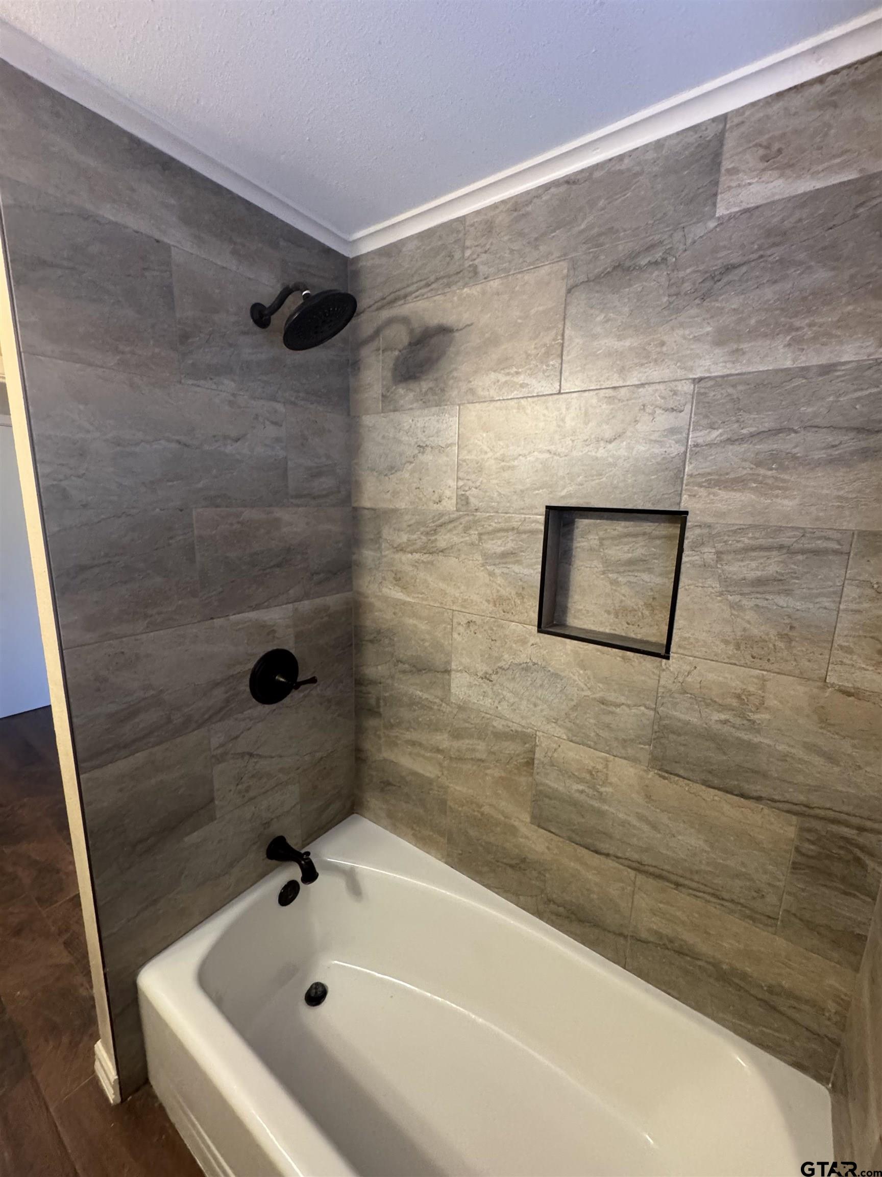 1823 Overbrook Drive Tyler, TX 75703 - Photo 28 of 48 a bathroom with a bathtub