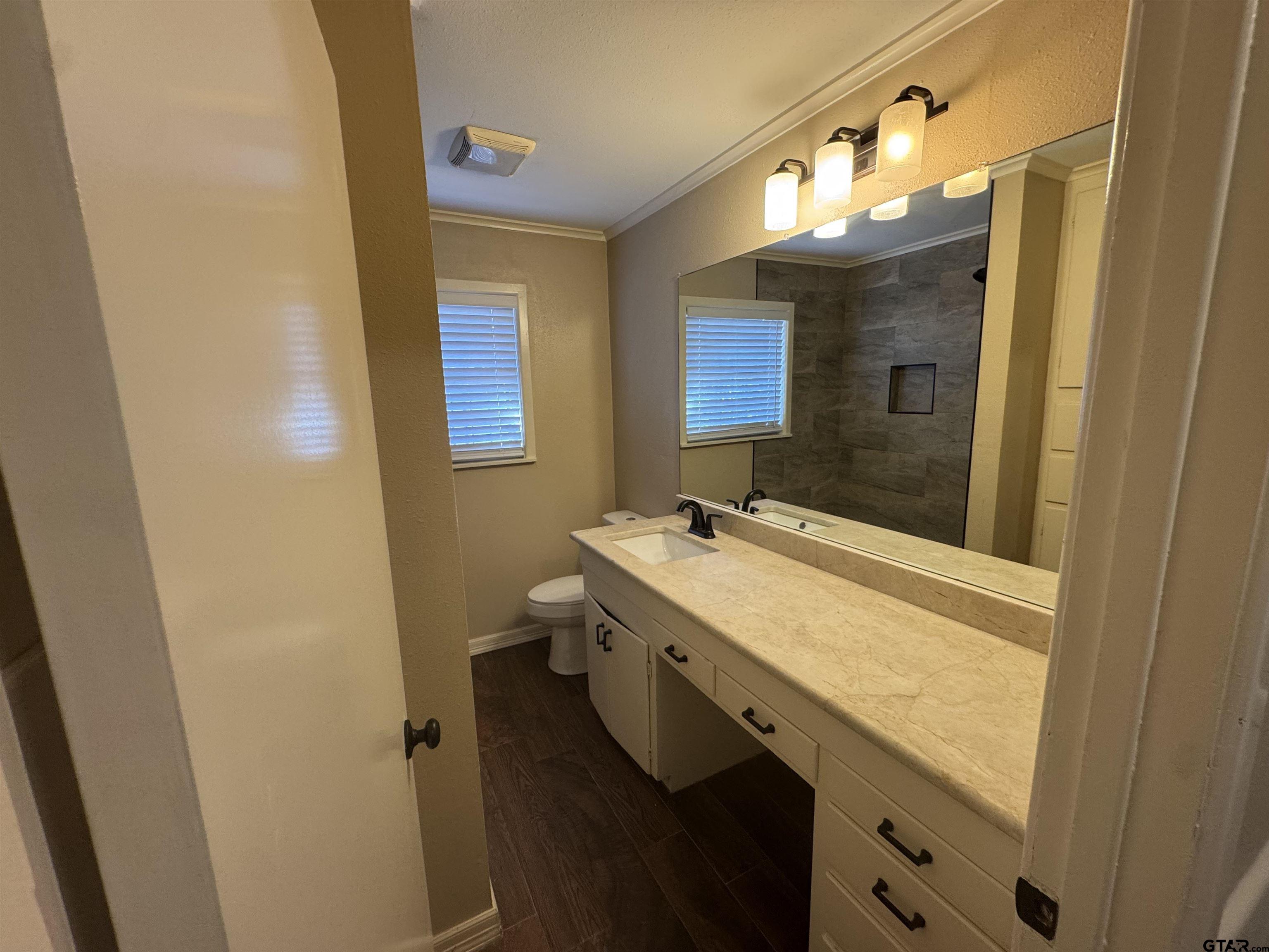 1823 Overbrook Drive Tyler, TX 75703 - Photo 29 of 48 a bathroom with a granite countertop sink toilet and shower