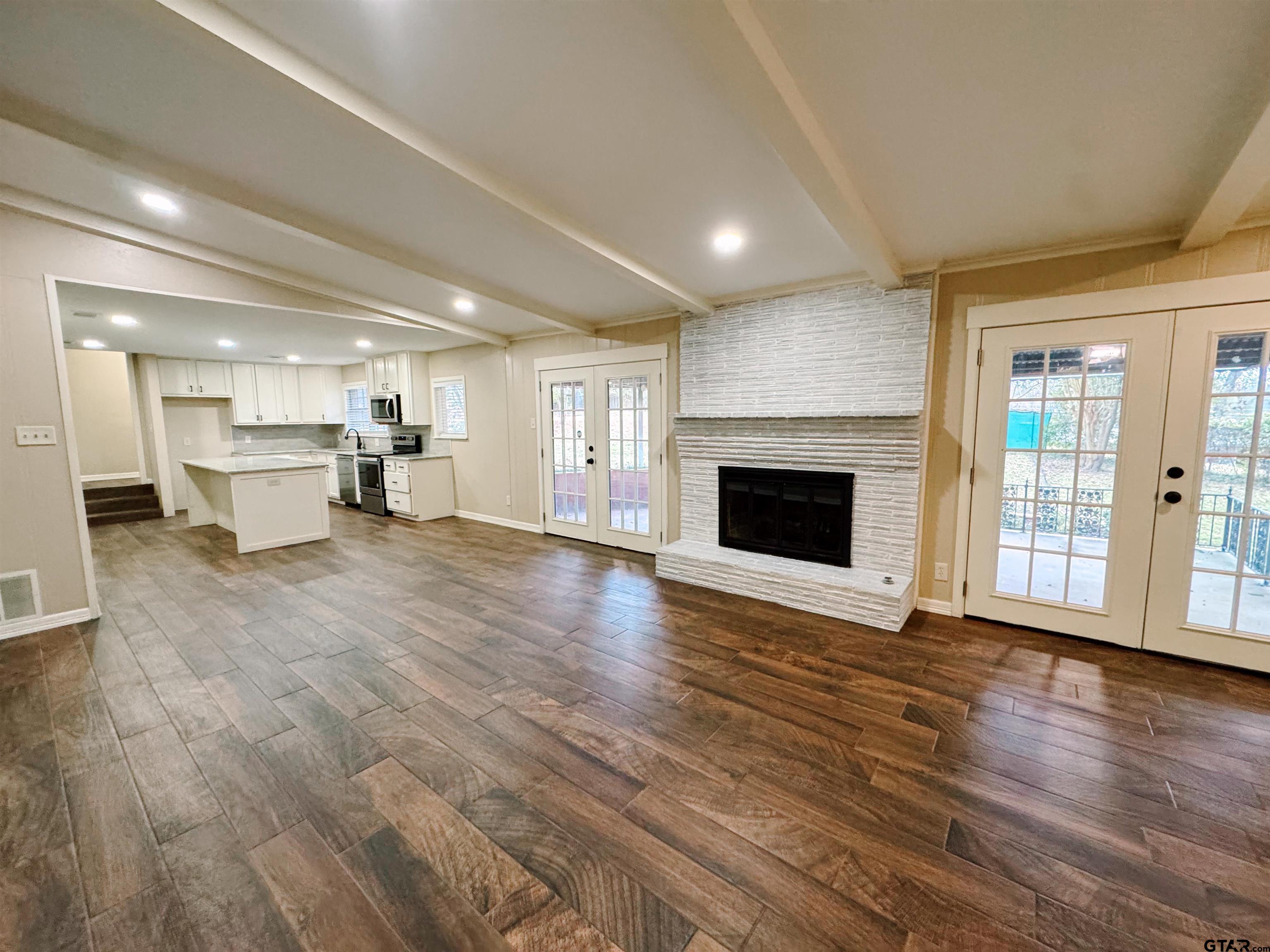 1823 Overbrook Drive Tyler, TX 75703 - Photo 3 of 48 an empty room with furniture and a fireplace