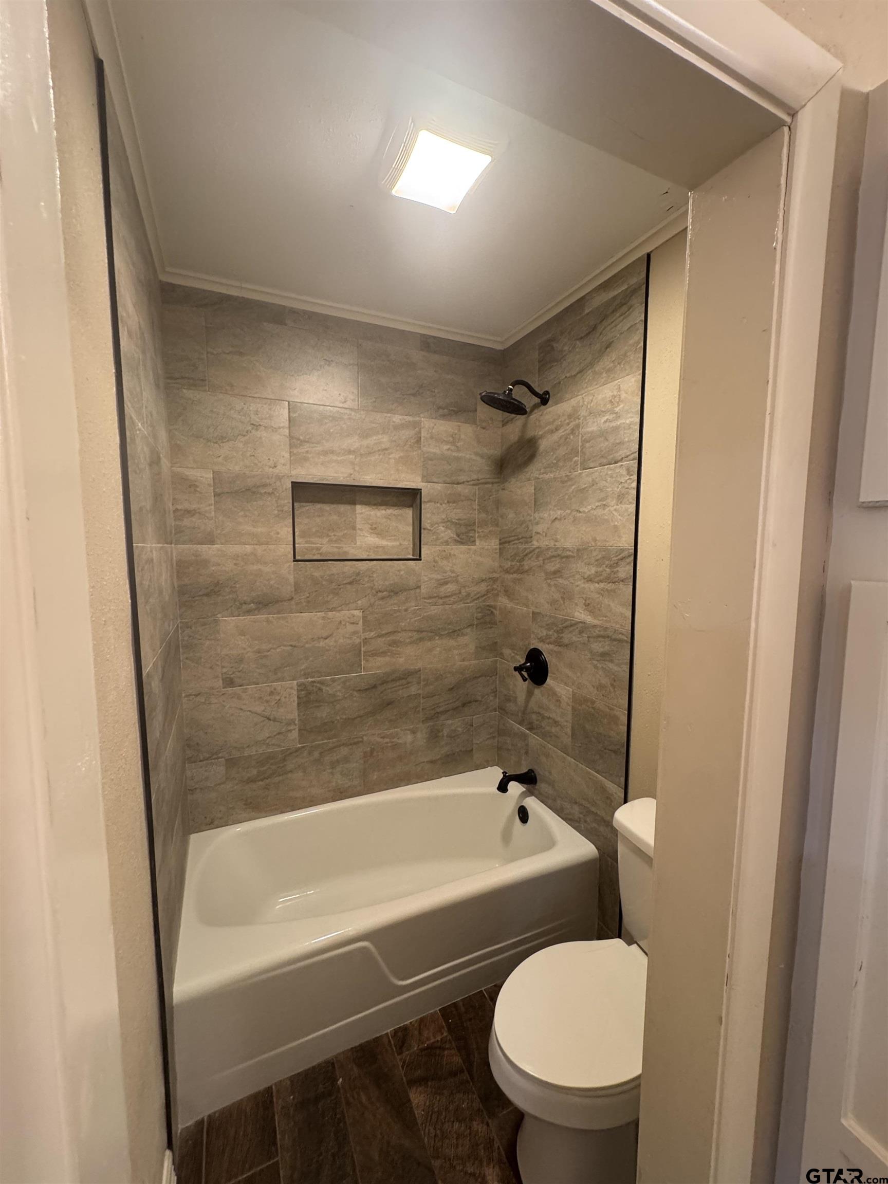 1823 Overbrook Drive Tyler, TX 75703 - Photo 35 of 48 a bathroom with a bathtub and a toilet