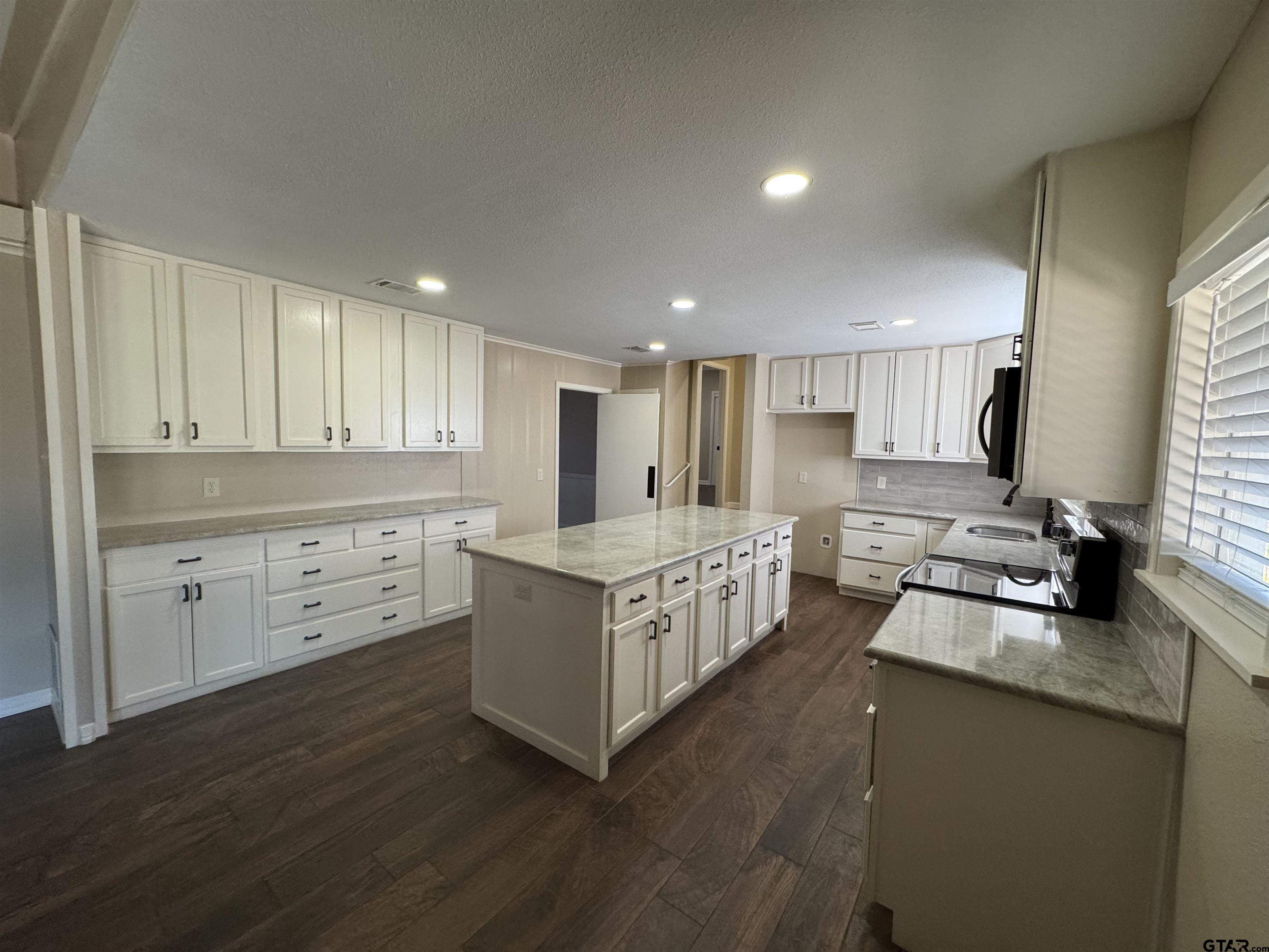 1823 Overbrook Drive Tyler, TX 75703 - Photo 6 of 48 a kitchen with stove a sink and cabinets