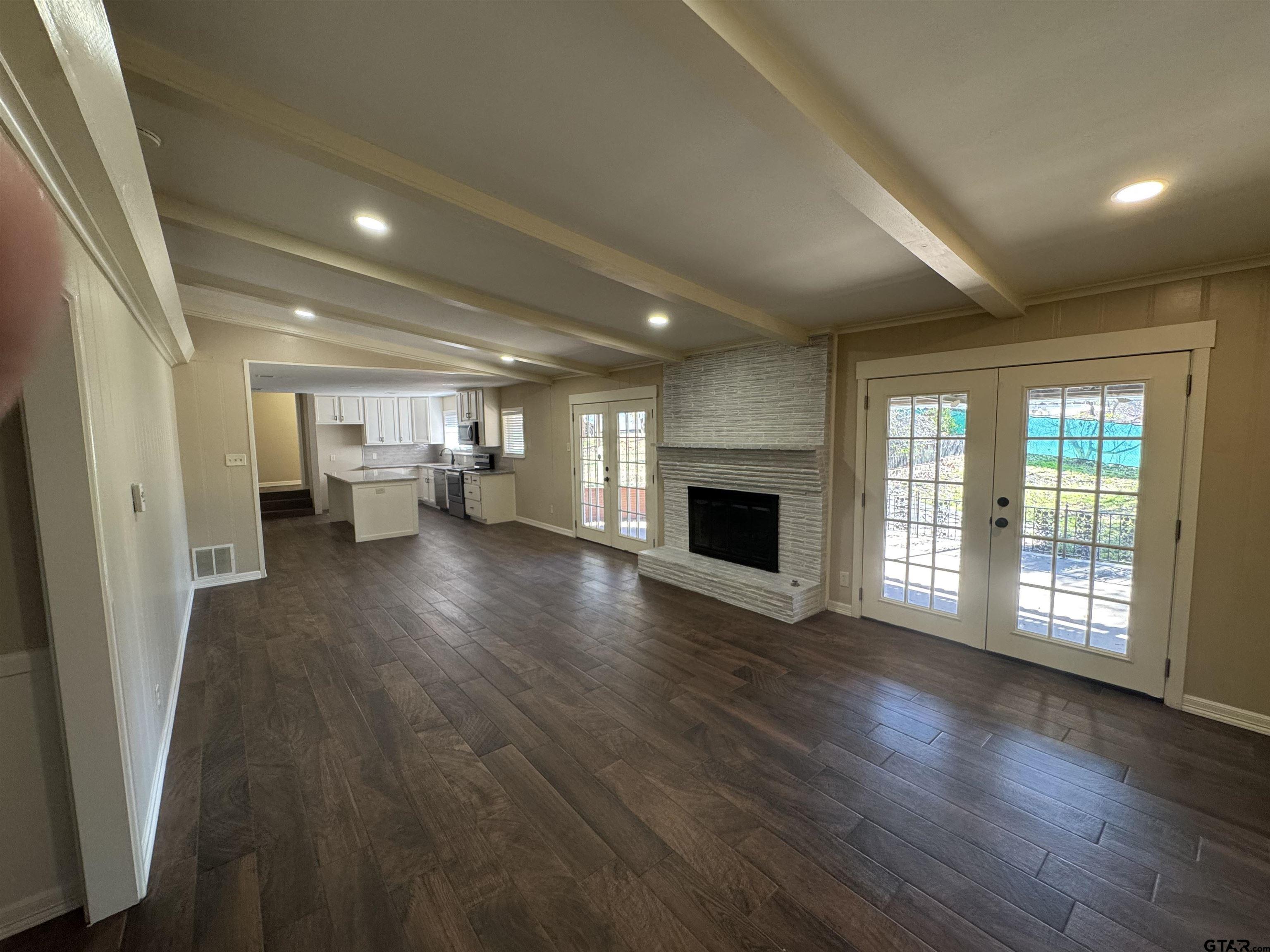 1823 Overbrook Drive Tyler, TX 75703 - Photo 8 of 48 wooden floor in an empty room with a fireplace
