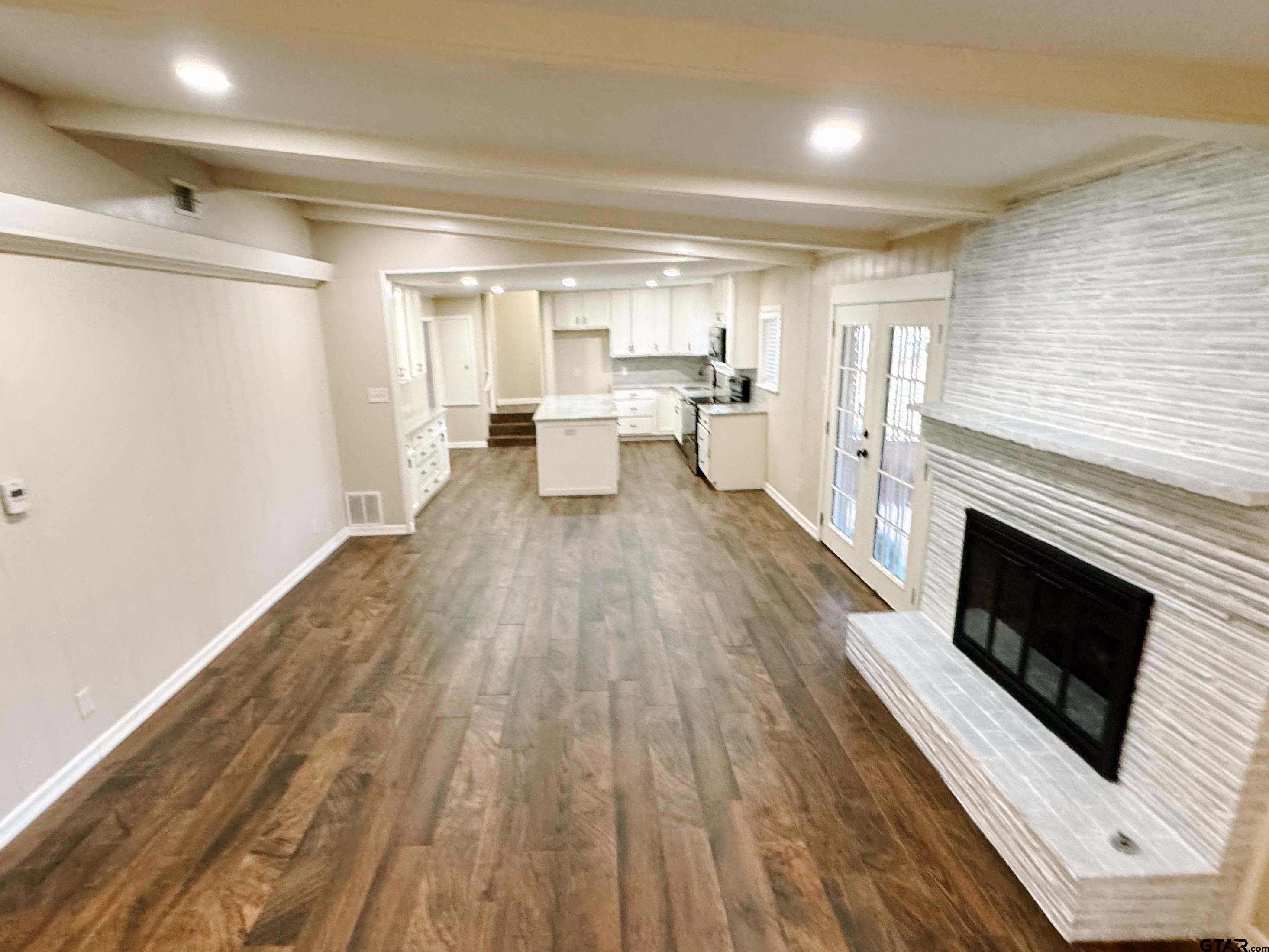 1823 Overbrook Drive Tyler, TX 75703 - Photo 9 of 48 a view of a living room a wooden floor and a fireplace