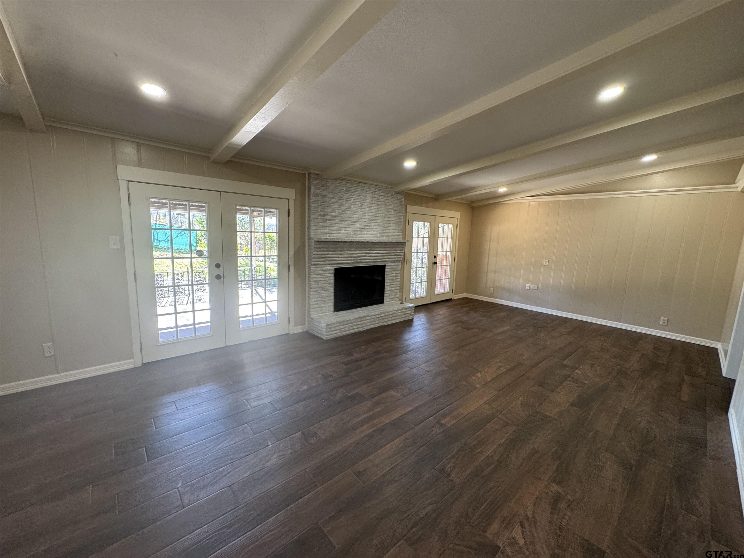 1823 Overbrook Drive Tyler, TX 75703 - Photo 10 of 48 an empty room with wooden floor and windows