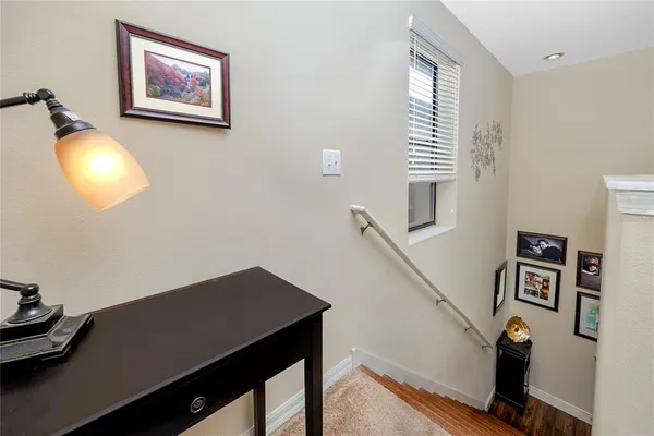 a view of a workspace with furniture and a window