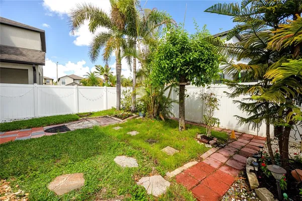 a view of backyard of house with green space