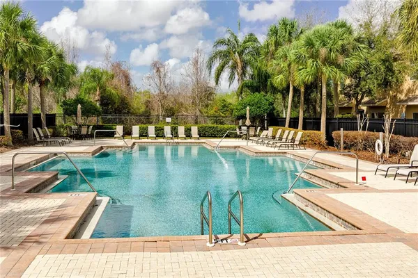 a swimming pool with barbeque oven outdoor seating