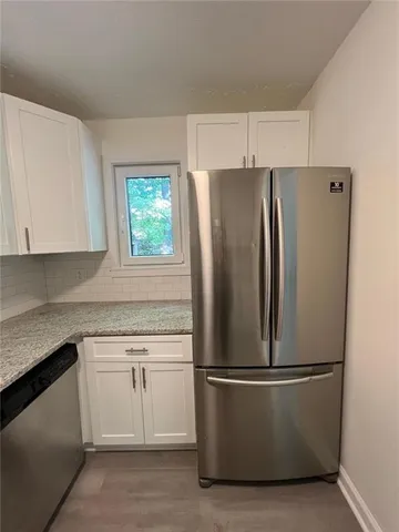 a white refrigerator freezer sitting in a kitchen