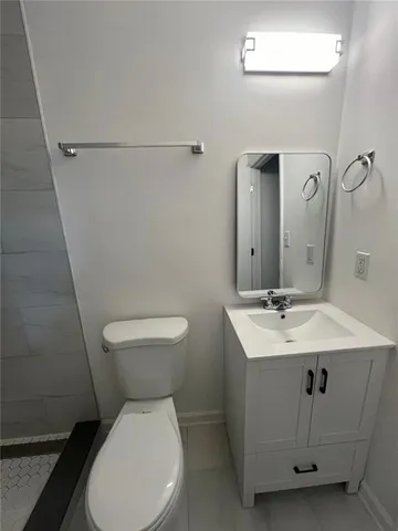 an empty room with windows and ceiling fan view