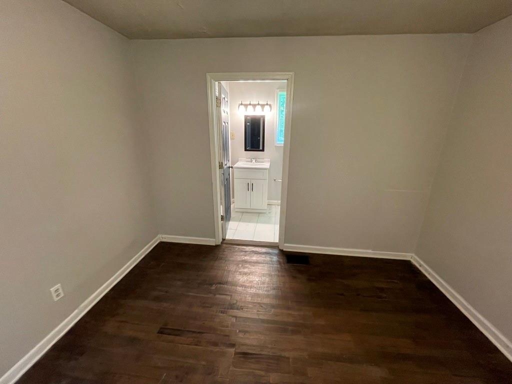 1642 Mary George Avenue Northwest Atlanta, GA 30318 - Photo 15 of 33 a view of a room with wooden floor and a window