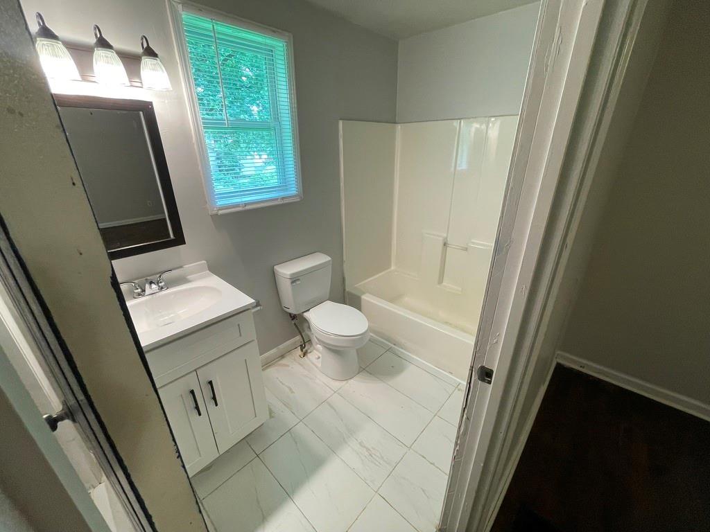 1642 Mary George Avenue Northwest Atlanta, GA 30318 - Photo 17 of 33 a bathroom with a sink a toilet and a mirror