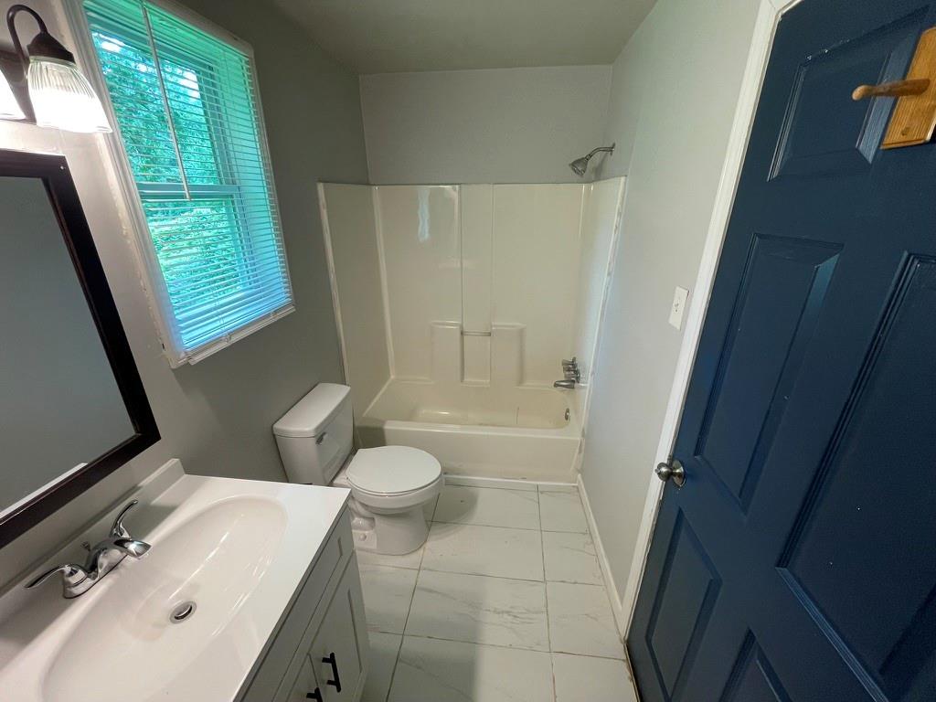1642 Mary George Avenue Northwest Atlanta, GA 30318 - Photo 18 of 33 a bathroom with a sink a toilet a tub and shower