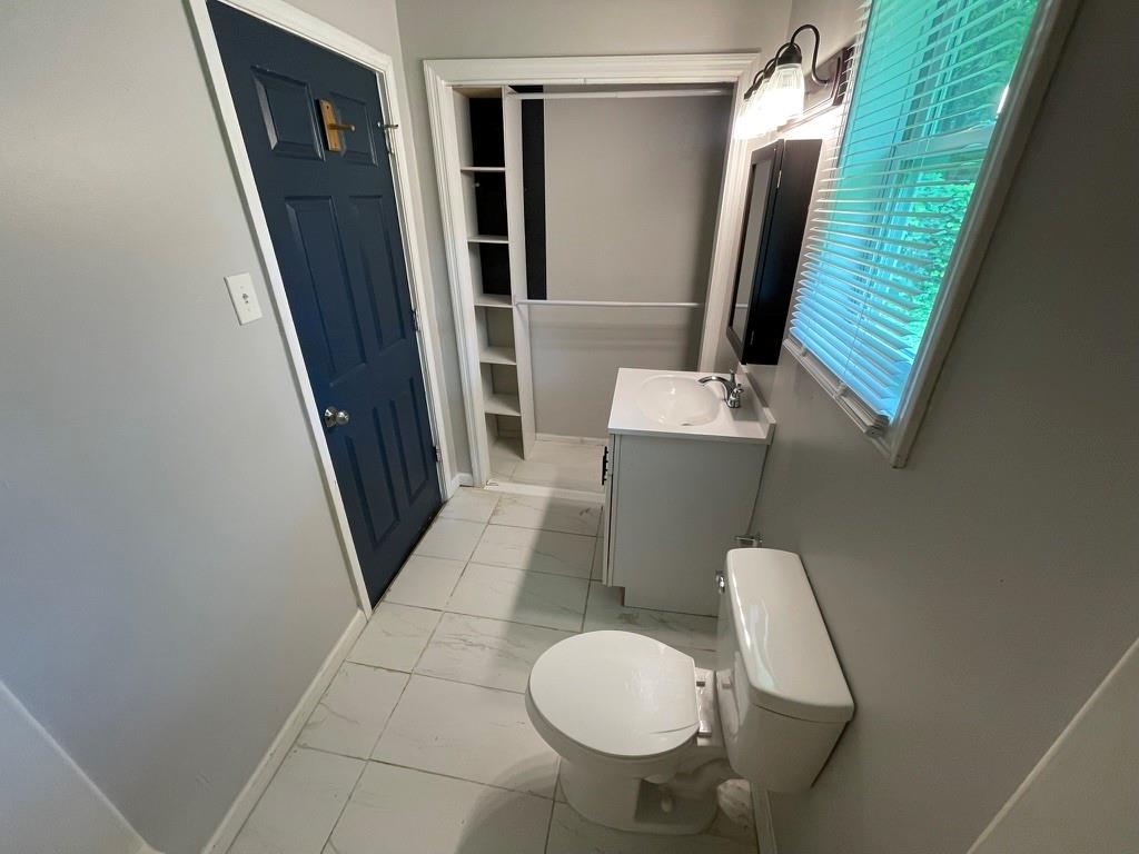 1642 Mary George Avenue Northwest Atlanta, GA 30318 - Photo 19 of 33 a bathroom with a toilet and a mirror